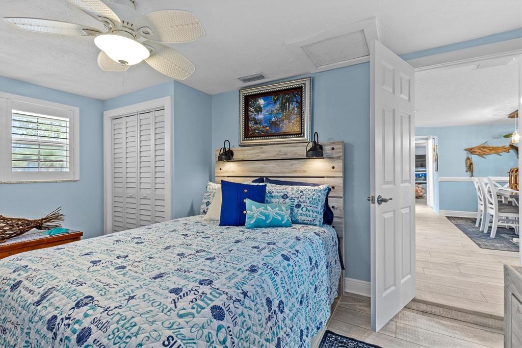 4387 6th Isle Drive Hernando Beach, FL 34607 - Photo 52 of 89 a bedroom with a bed and a chandelier