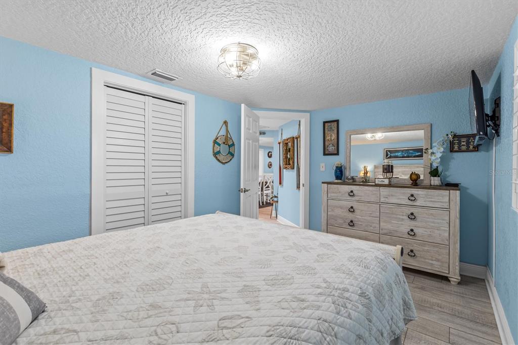 4387 6th Isle Drive Hernando Beach, FL 34607 - Photo 57 of 98 a bedroom with a bed and a dresser