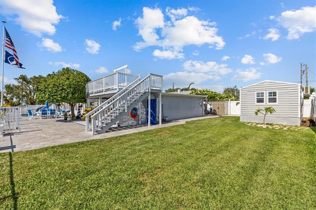 4387 6th Isle Drive Hernando Beach, FL 34607 - Photo 64 of 98 a view of a house with a big yard and a large tree
