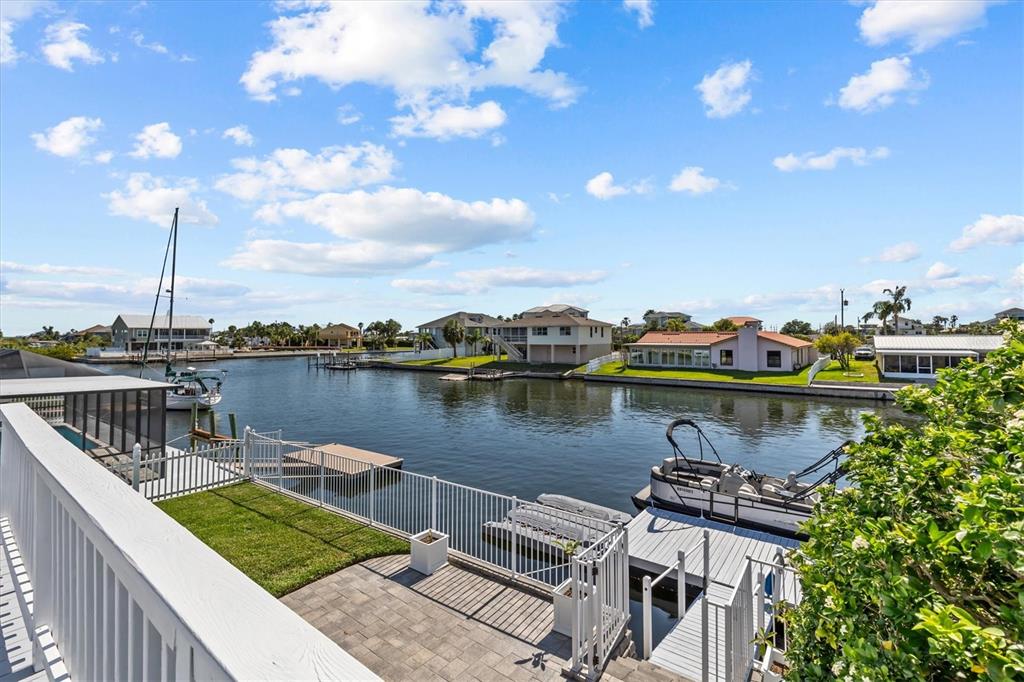 4387 6th Isle Drive Hernando Beach, FL 34607 - Photo 75 of 98 a view of a lake with boats and trees in the background