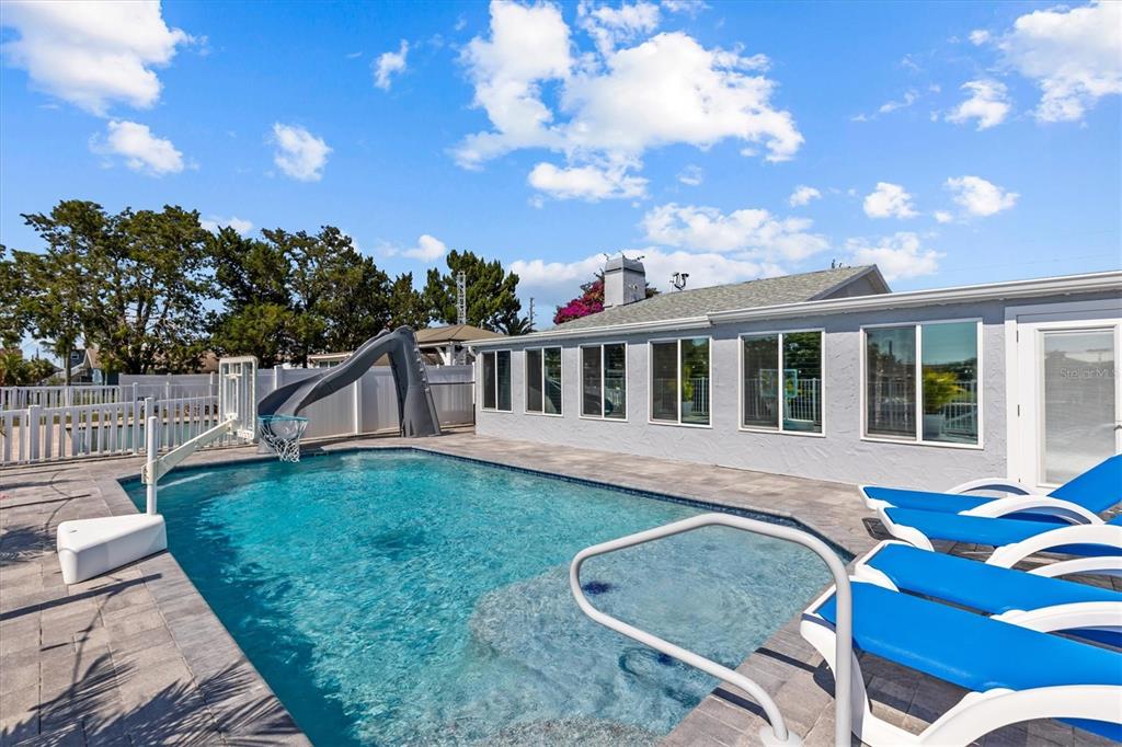 4387 6th Isle Drive Hernando Beach, FL 34607 - Photo 83 of 98 a view of a house with backyard porch and furniture