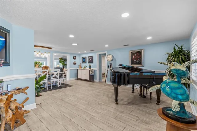 a kitchen with stainless steel appliances kitchen island granite countertop a sink and a refrigerator