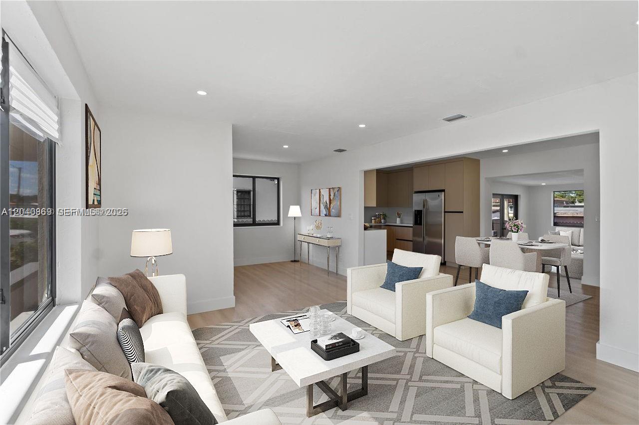 31 West 64th Street Hialeah, FL 33012 - Photo 8 of 49 a living room with furniture a table and kitchen view