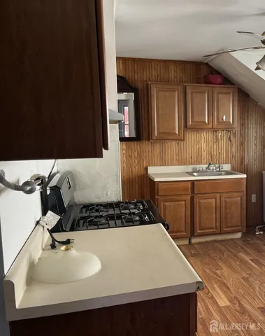 a kitchen with a sink and a stove top oven