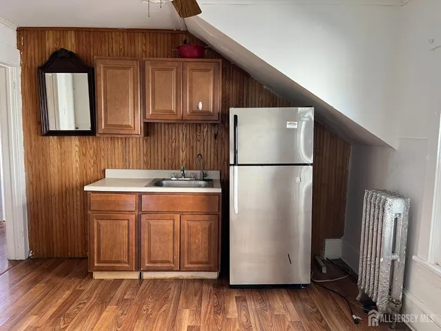 a kitchen with stainless steel appliances a refrigerator and a cabinets