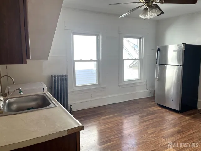a kitchen with a refrigerator sink and cabinets