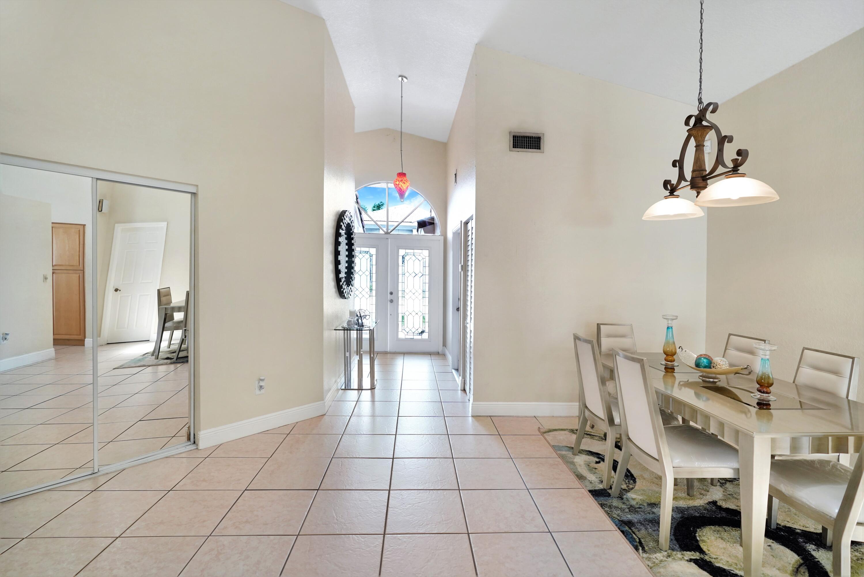 14001 Oak Ridge Drive Davie, FL 33325 - Photo 11 of 41 a view of a dining room with furniture and chandelier