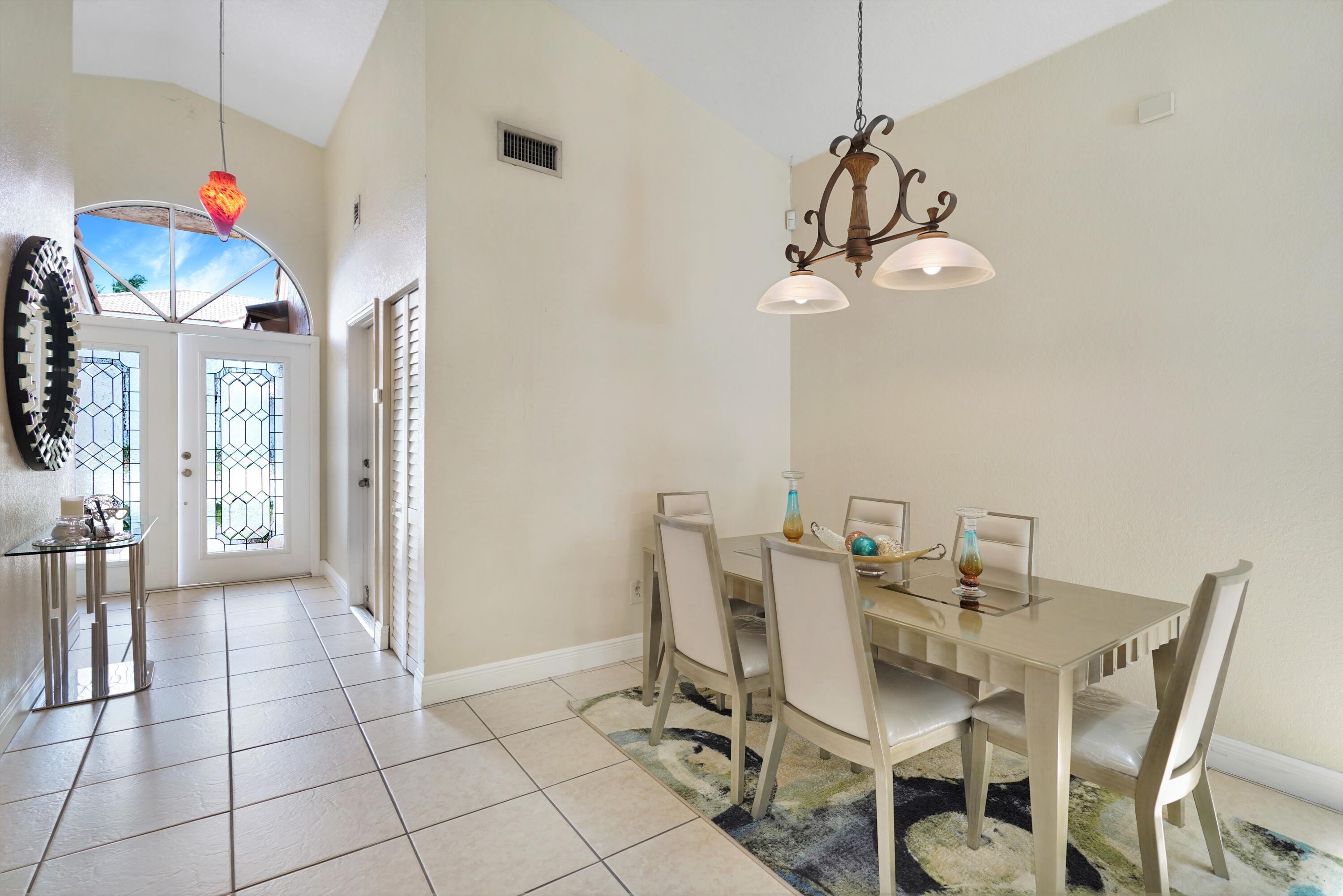 14001 Oak Ridge Drive Davie, FL 33325 - Photo 12 of 41 a view of a dining room with furniture and chandelier