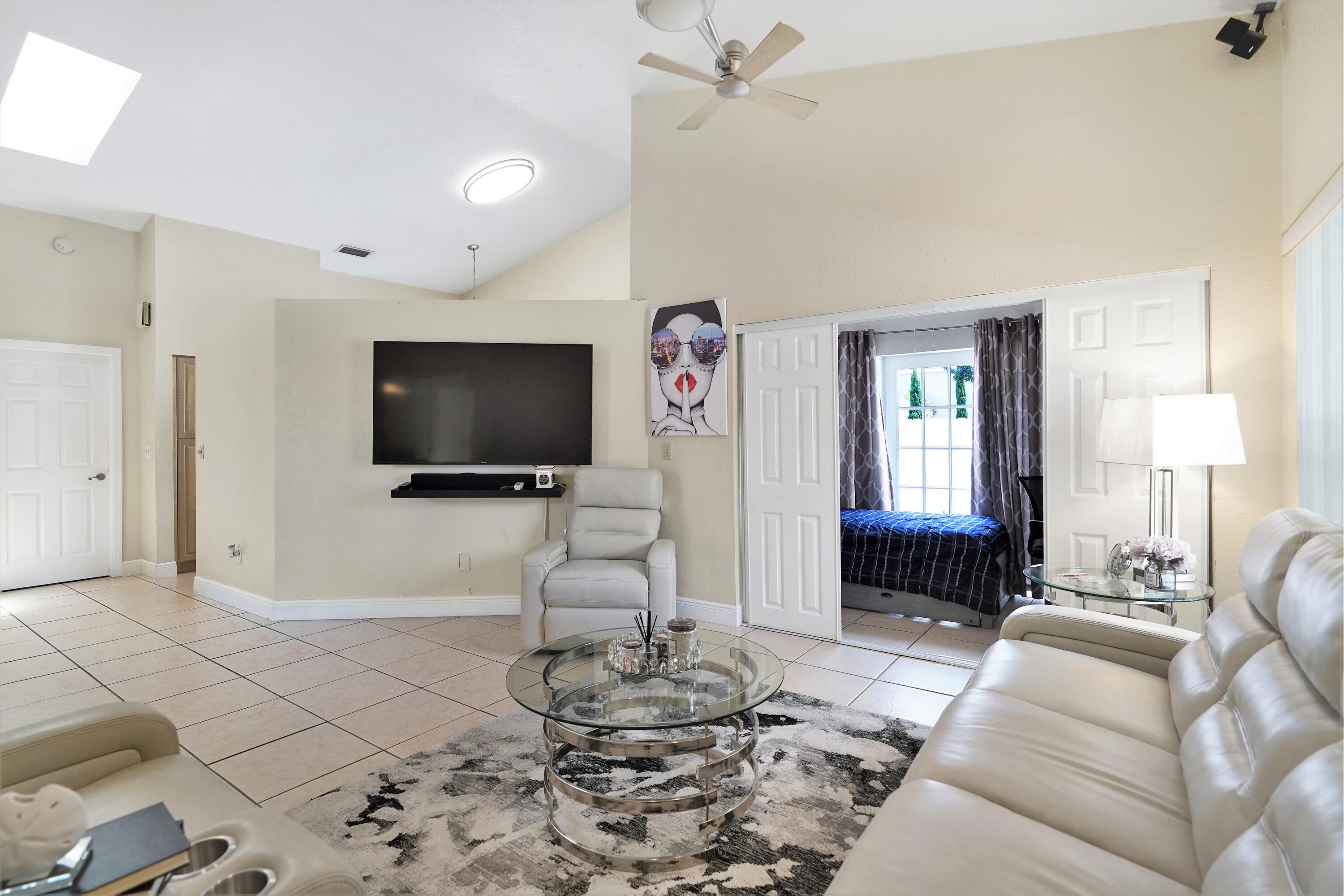 14001 Oak Ridge Drive Davie, FL 33325 - Photo 14 of 41 a living room with furniture and a flat screen tv
