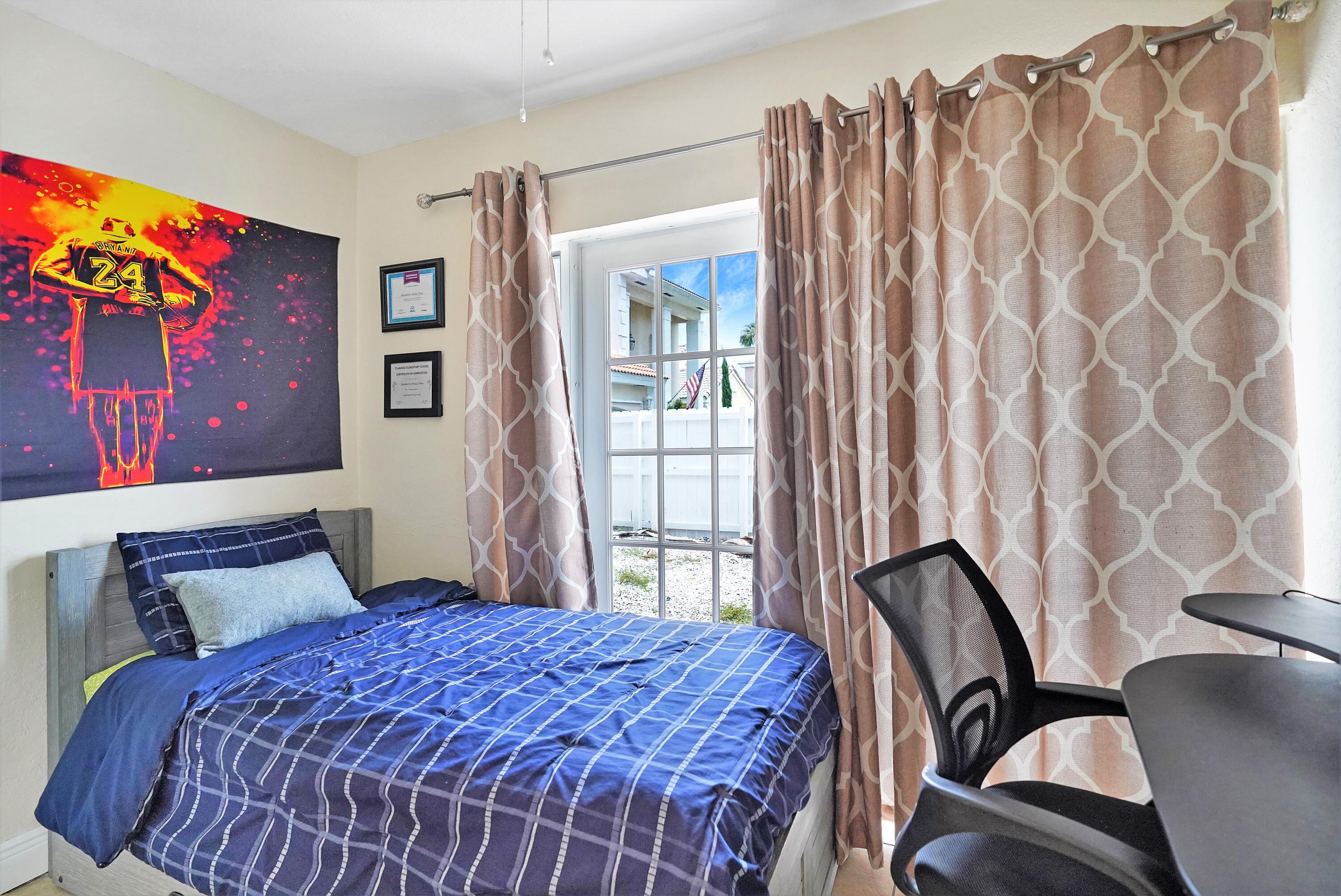 14001 Oak Ridge Drive Davie, FL 33325 - Photo 17 of 41 a bedroom with a bed and a chair