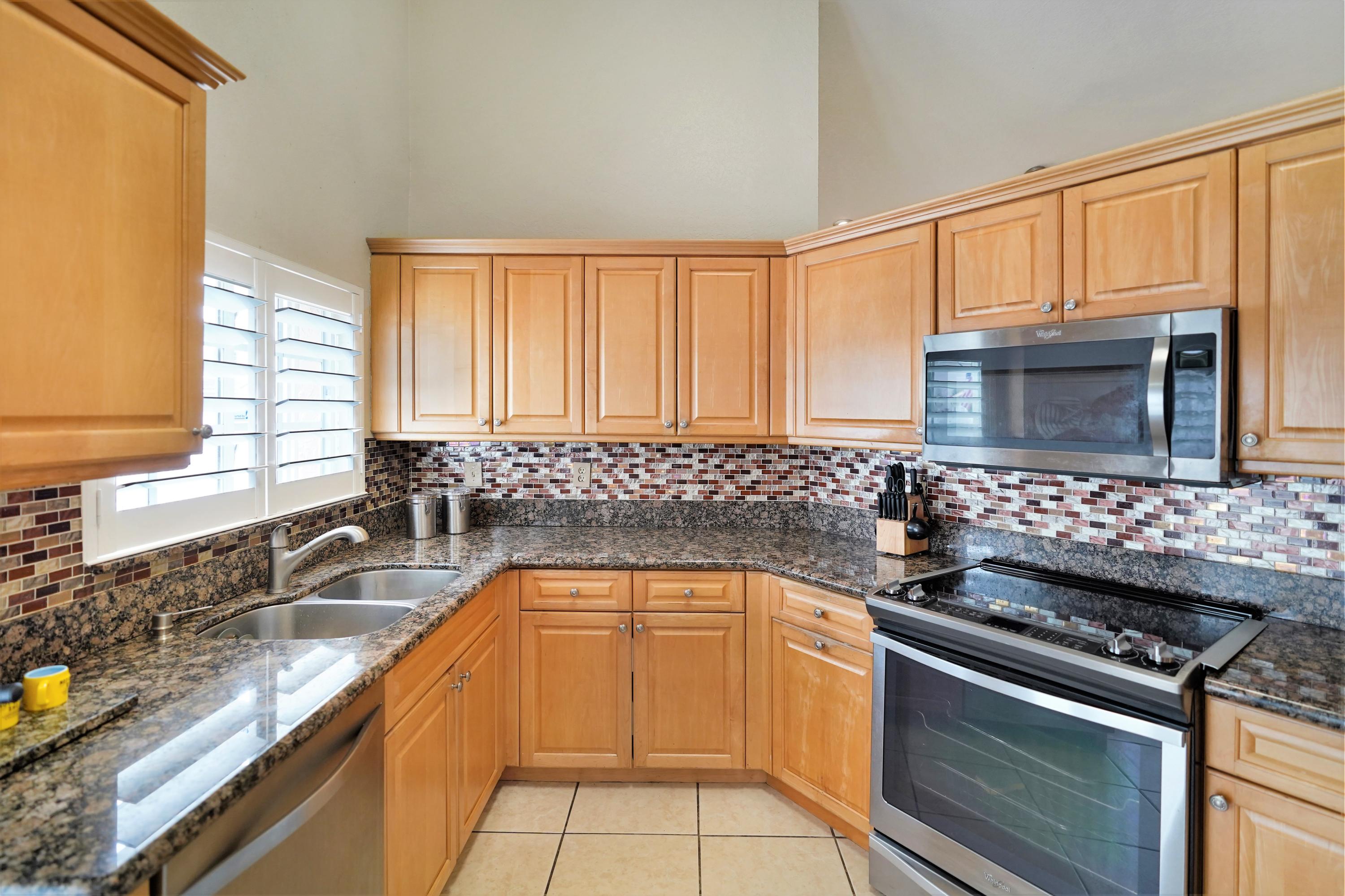14001 Oak Ridge Drive Davie, FL 33325 - Photo 20 of 41 a kitchen with granite countertop a sink stainless steel appliances a counter space and cabinets