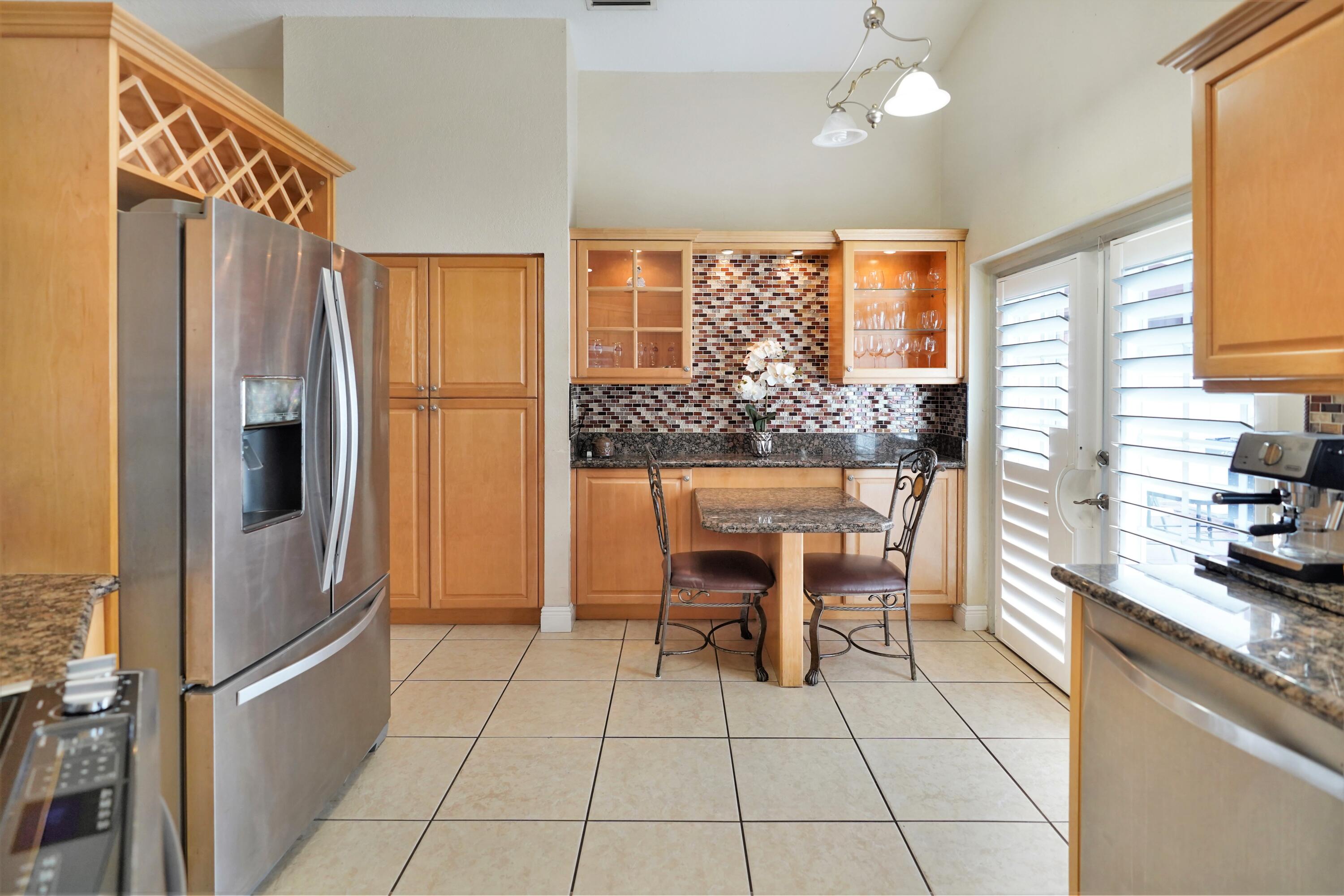 14001 Oak Ridge Drive Davie, FL 33325 - Photo 22 of 41 a kitchen with stainless steel appliances granite countertop a refrigerator and a stove