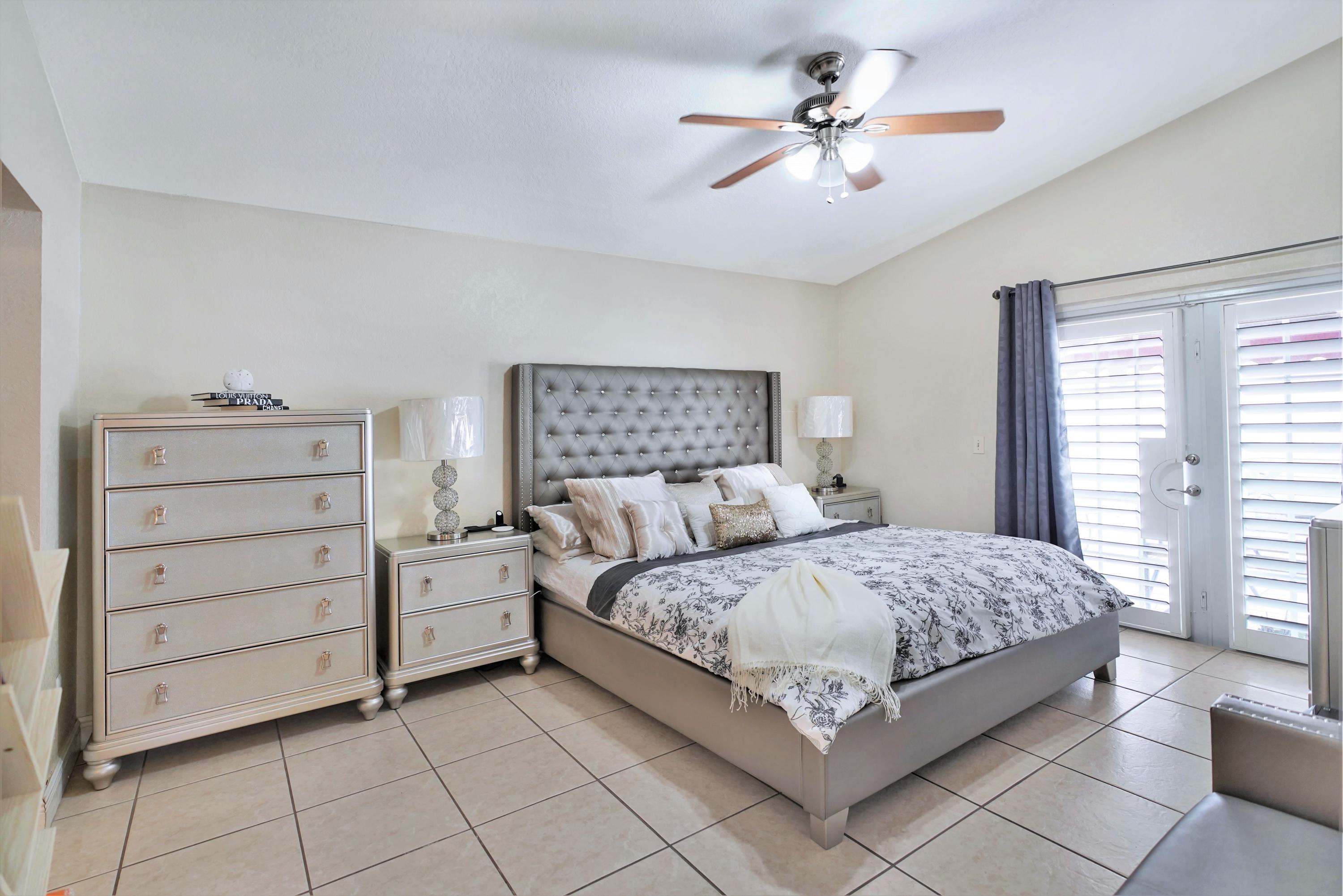 14001 Oak Ridge Drive Davie, FL 33325 - Photo 24 of 41 a bedroom with a bed and a ceiling fan