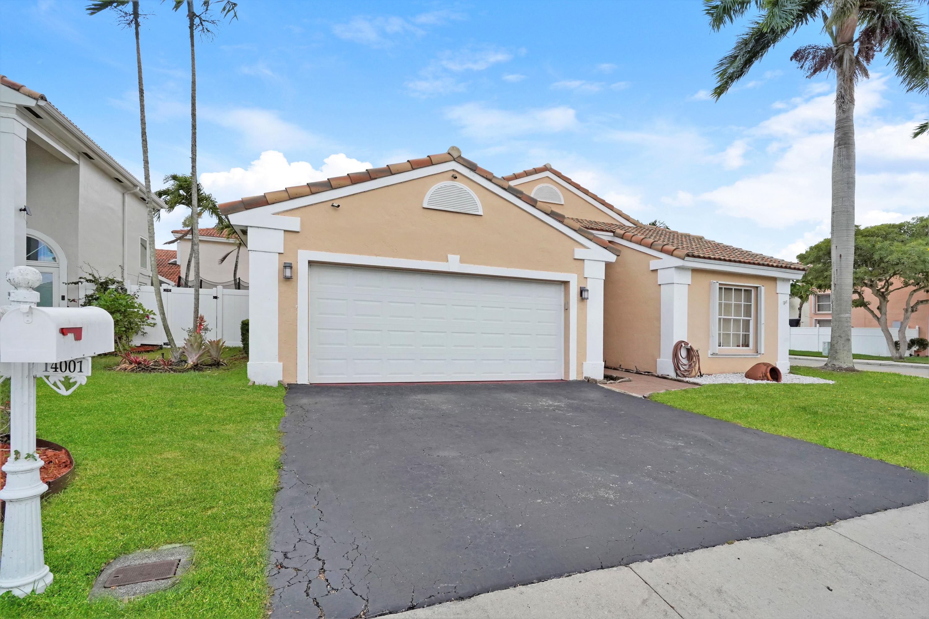 14001 Oak Ridge Drive Davie, FL 33325 - Photo 3 of 41 a view of a house with a yard and garage