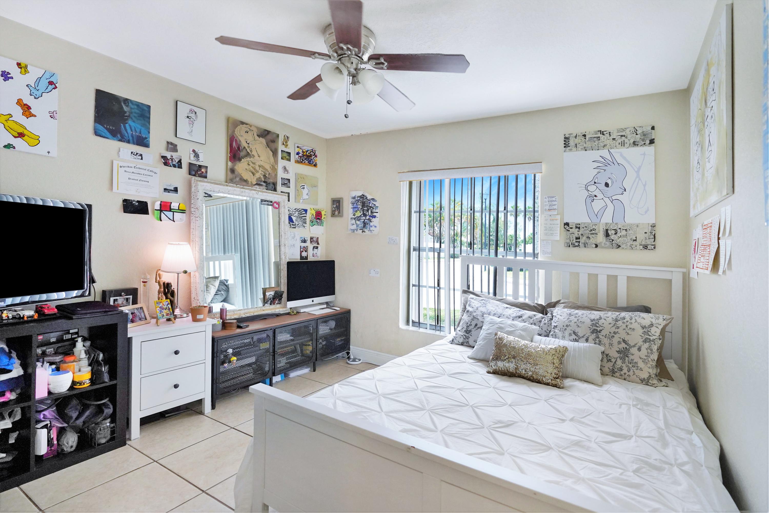 14001 Oak Ridge Drive Davie, FL 33325 - Photo 36 of 41 a bedroom with furniture and a flat screen tv