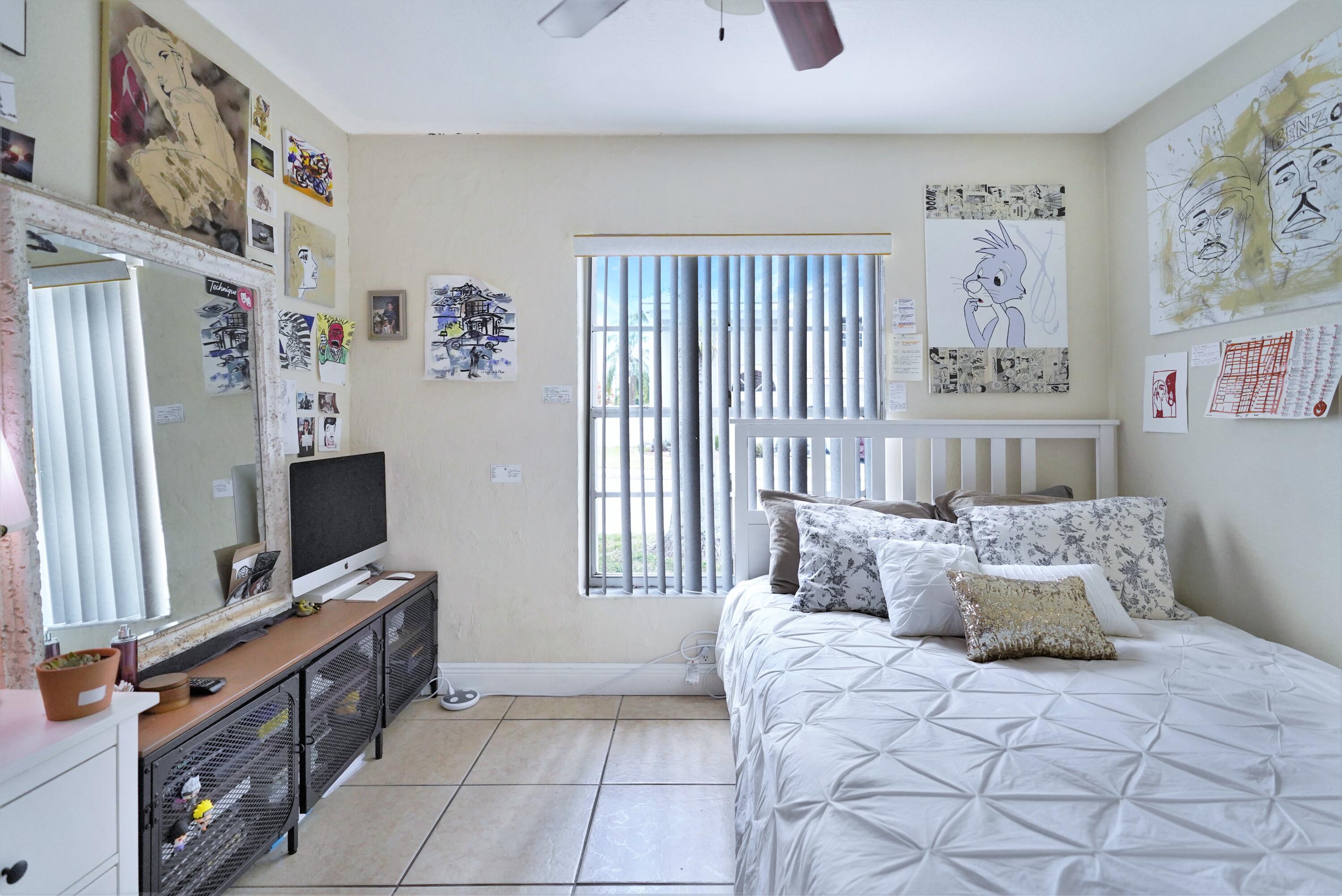 14001 Oak Ridge Drive Davie, FL 33325 - Photo 37 of 41 a spacious bedroom with a bed and a flat screen tv