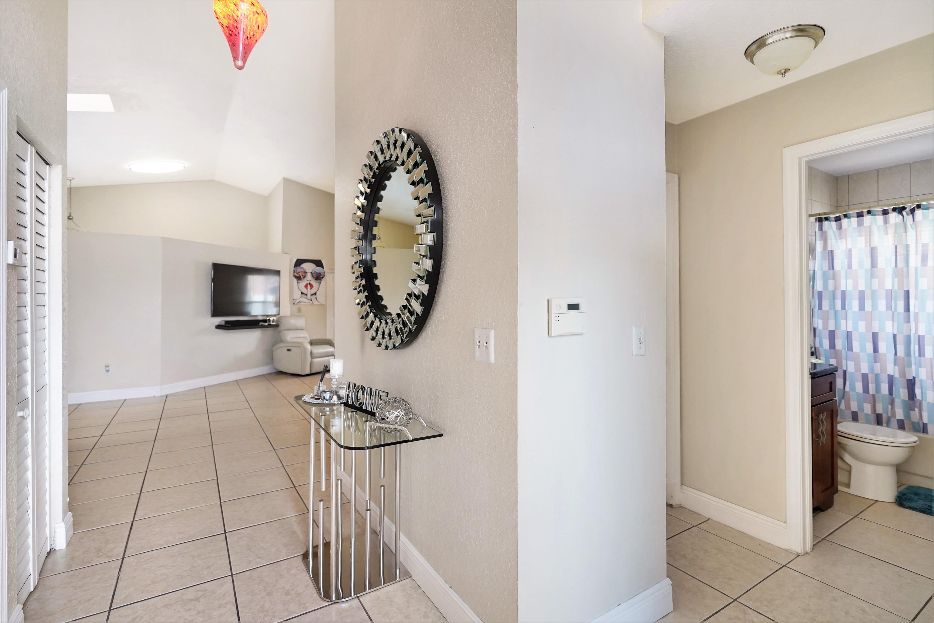 14001 Oak Ridge Drive Davie, FL 33325 - Photo 6 of 41 a bathroom with a sink and a mirror