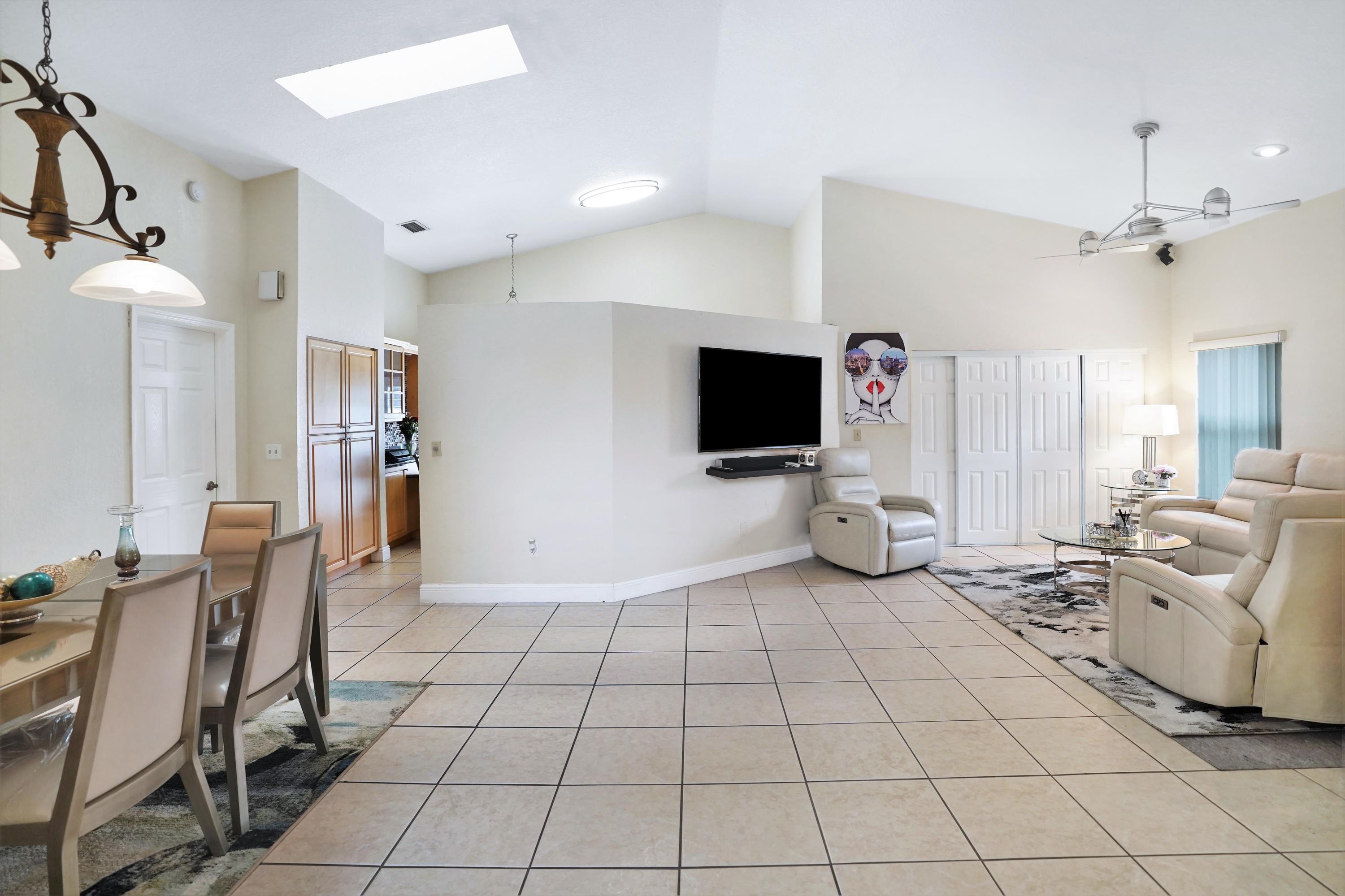 14001 Oak Ridge Drive Davie, FL 33325 - Photo 8 of 41 a living room with furniture and a flat screen tv