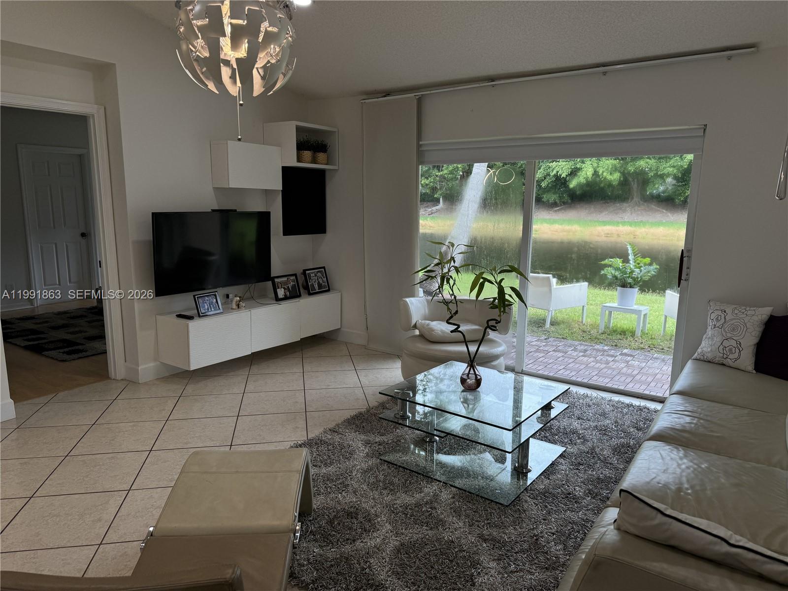 2002 Andromeda Lane Fort Lauderdale, FL 33327 - Photo 3 of 11 a living room with patio furniture and a flat screen tv