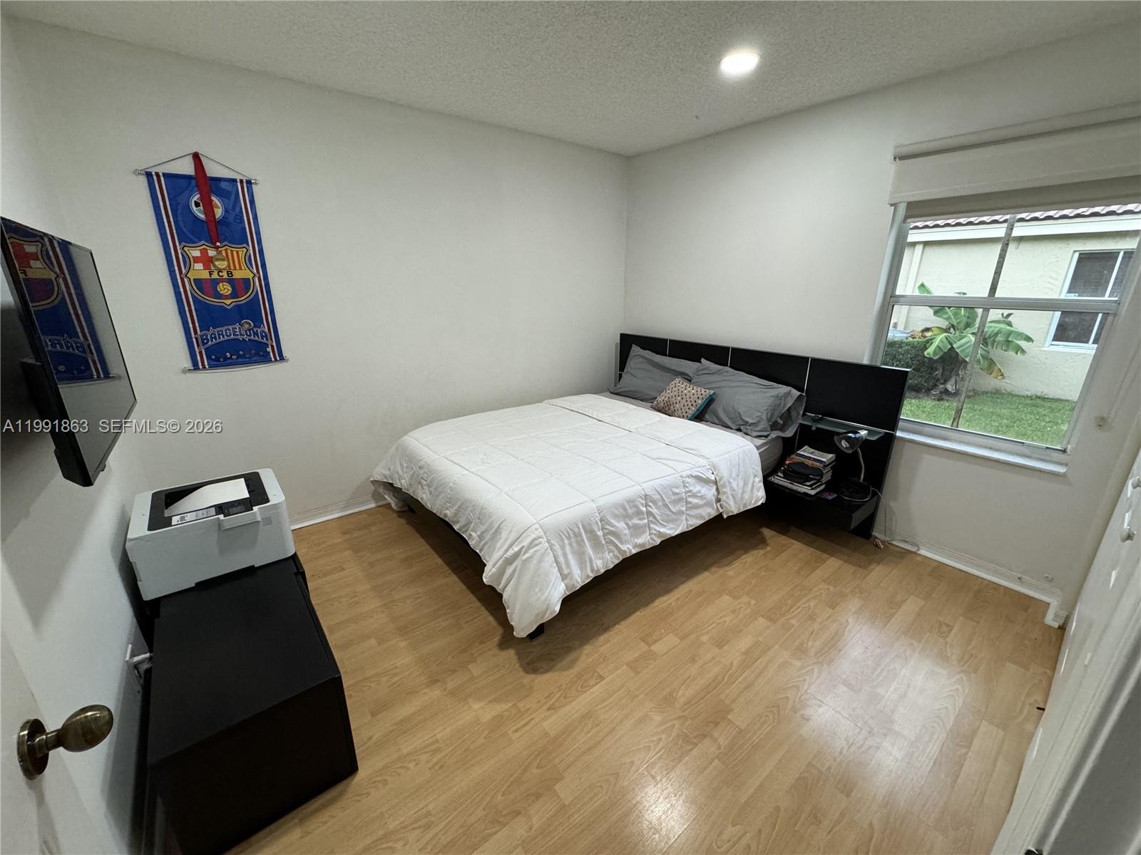 2002 Andromeda Lane Fort Lauderdale, FL 33327 - Photo 8 of 11 a bedroom with a bed and a painting on the wall