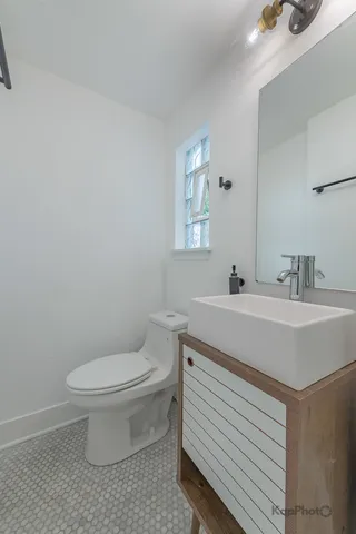 a bathroom with a sink toilet and a mirror