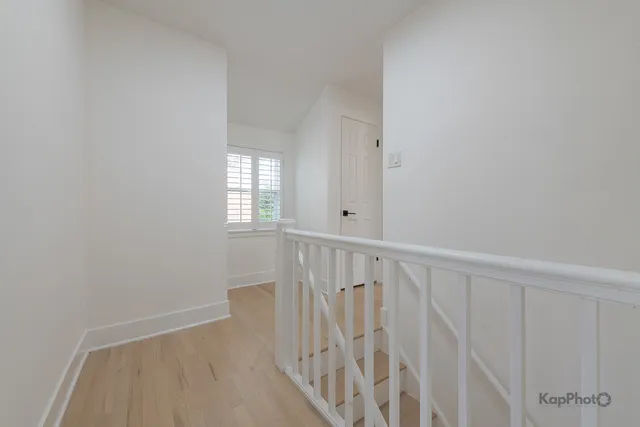 a view of an entryway with wooden floor