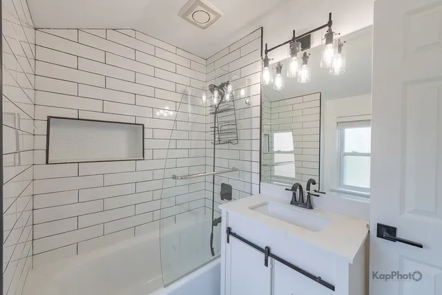 a bathroom with a shower and a sink