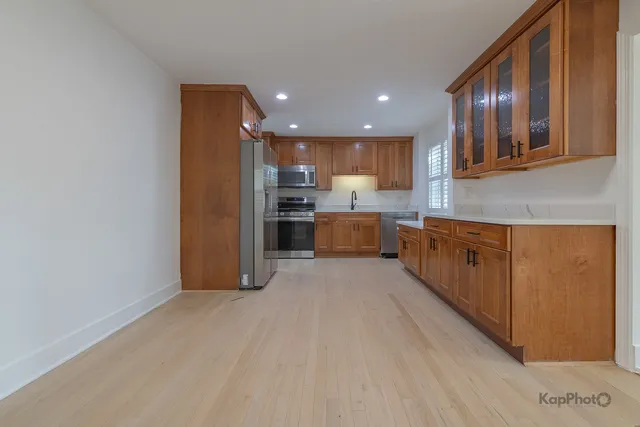 a view of kitchen and stainless steel appliances with cabinets
