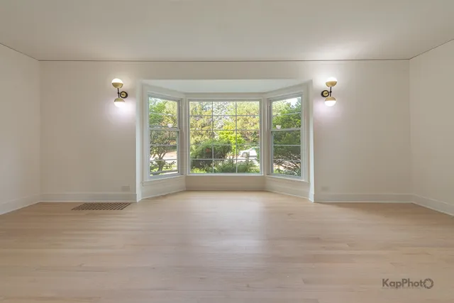 an empty room with large windows