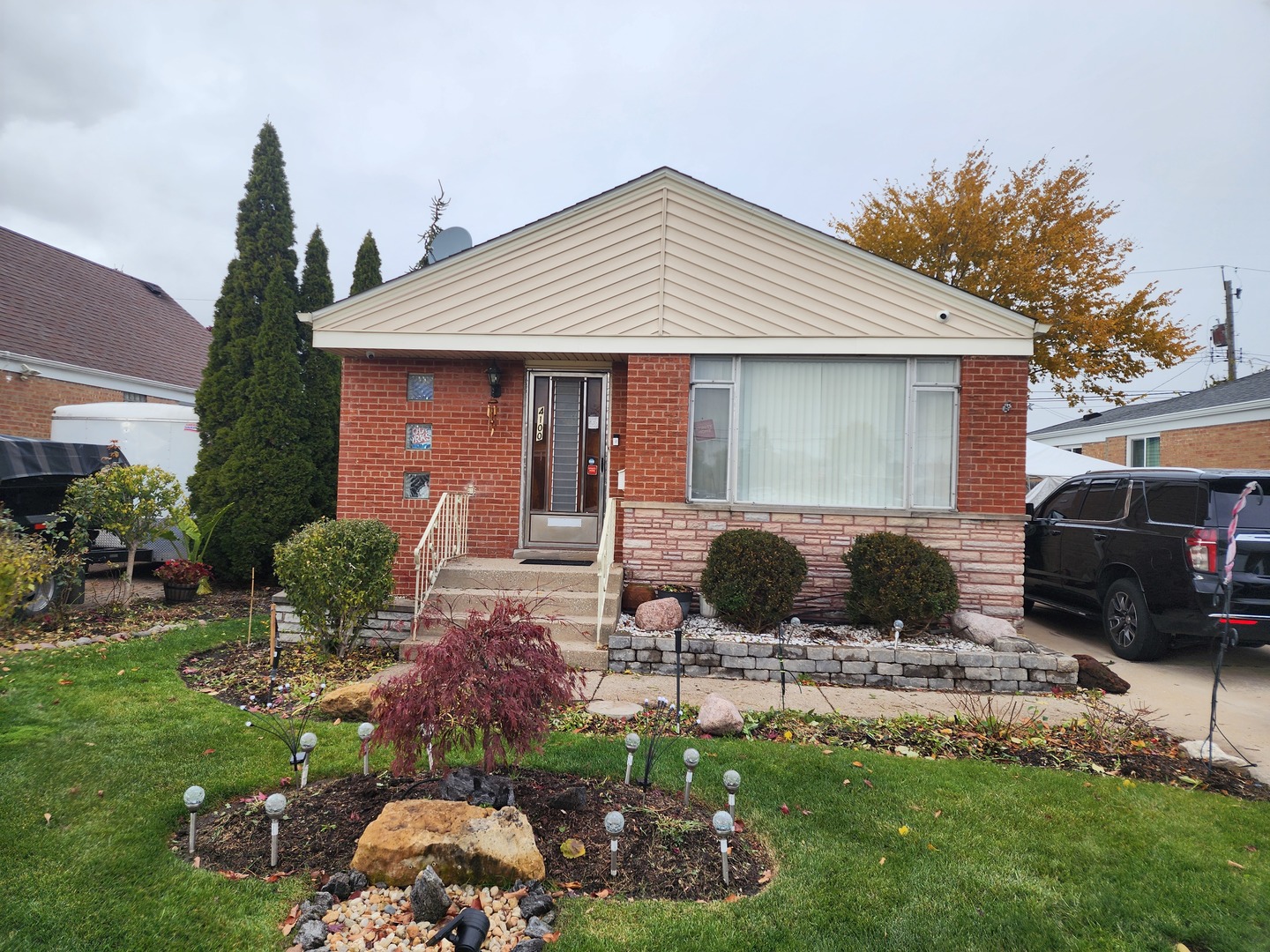 a view of a house with backyard sitting area and fire pit