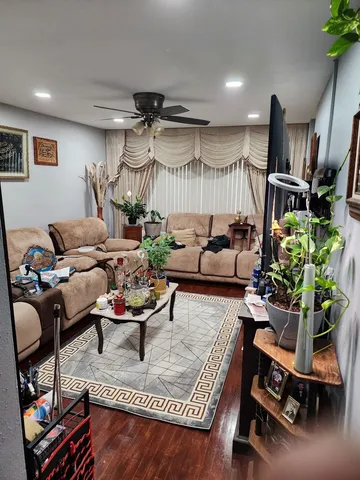 a living room with furniture gym equipment and a window