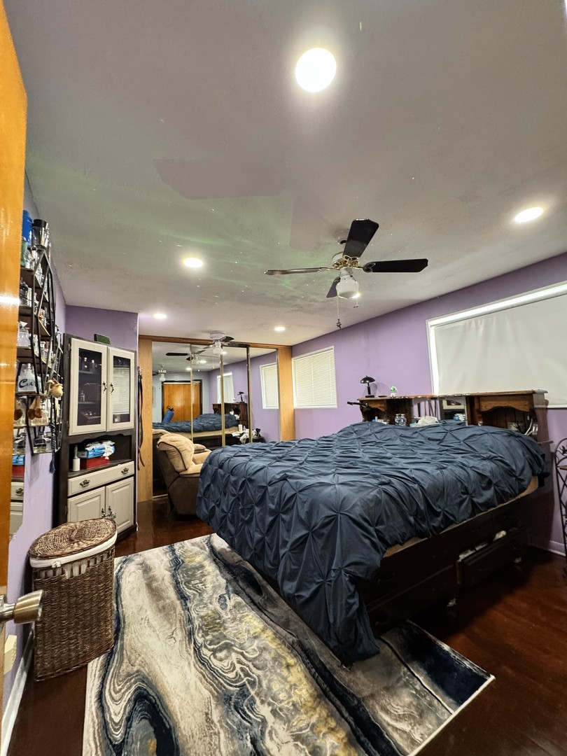 4100 West 81st Place Chicago, IL 60652 - Photo 4 of 9 a spacious bedroom with a bed a couch and dresser