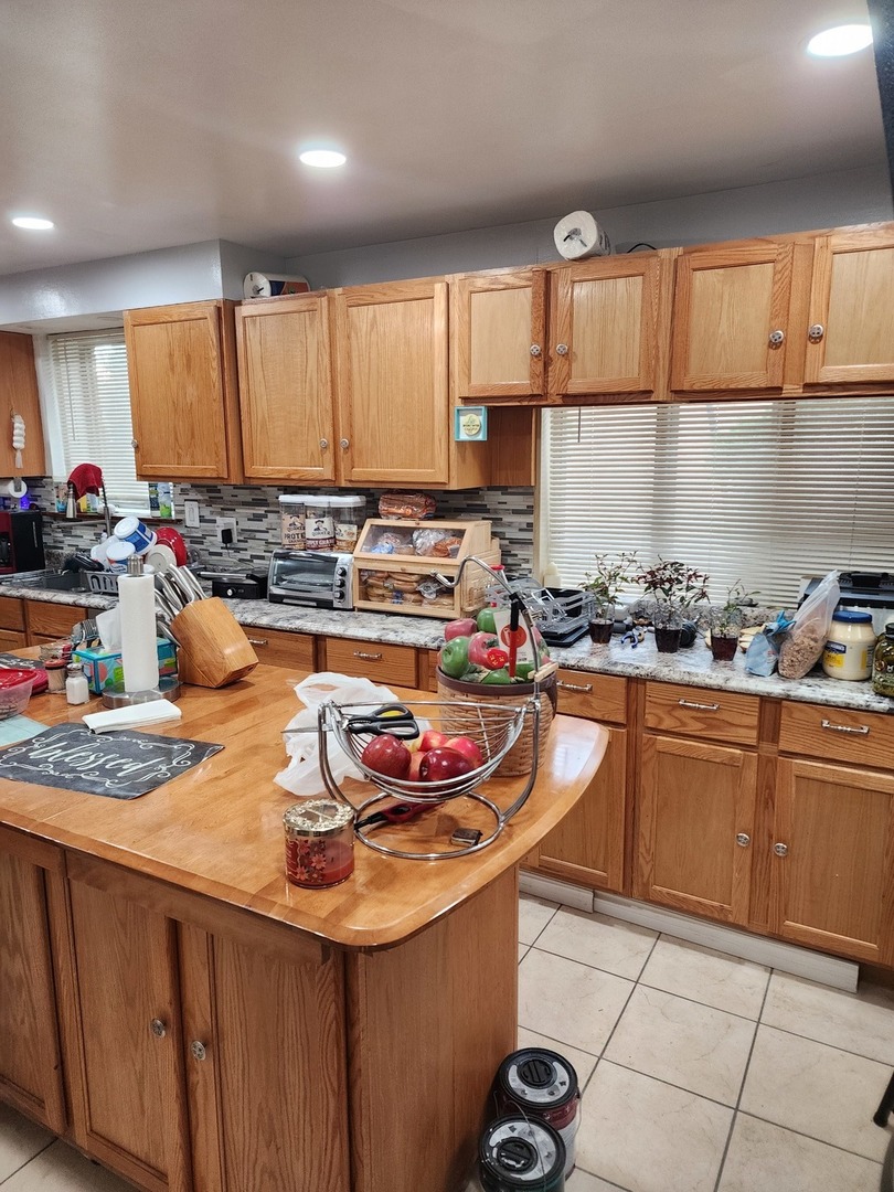4100 West 81st Place Chicago, IL 60652 - Photo 6 of 9 a kitchen with stainless steel appliances granite countertop a sink stove and cabinets