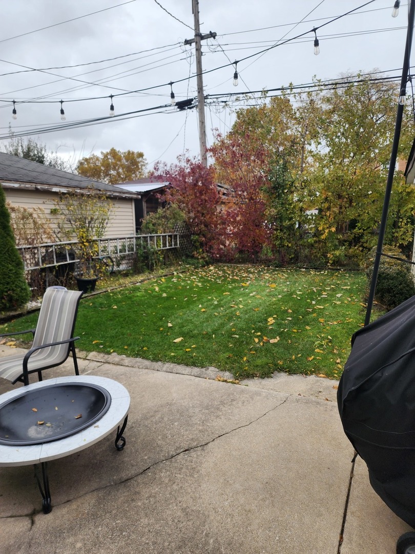 4100 West 81st Place Chicago, IL 60652 - Photo 7 of 9 a view of a chairs and table in backyard