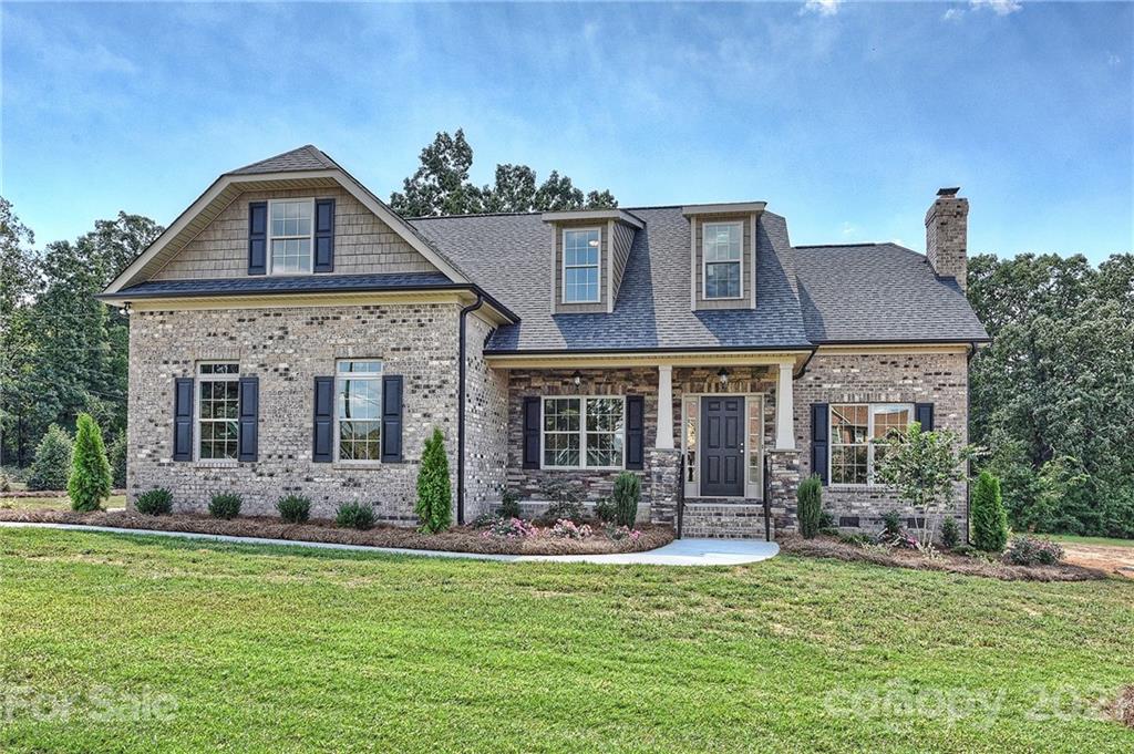 3324 Sincerity Road, Unit 6 Monroe, NC 28110 - Photo 1 of 29 a front view of a house with garden