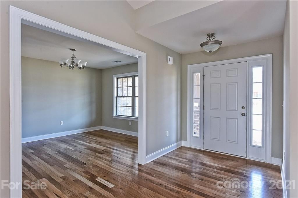 3324 Sincerity Road, Unit 6 Monroe, NC 28110 - Photo 2 of 29 a view of an empty room with wooden floor and a window