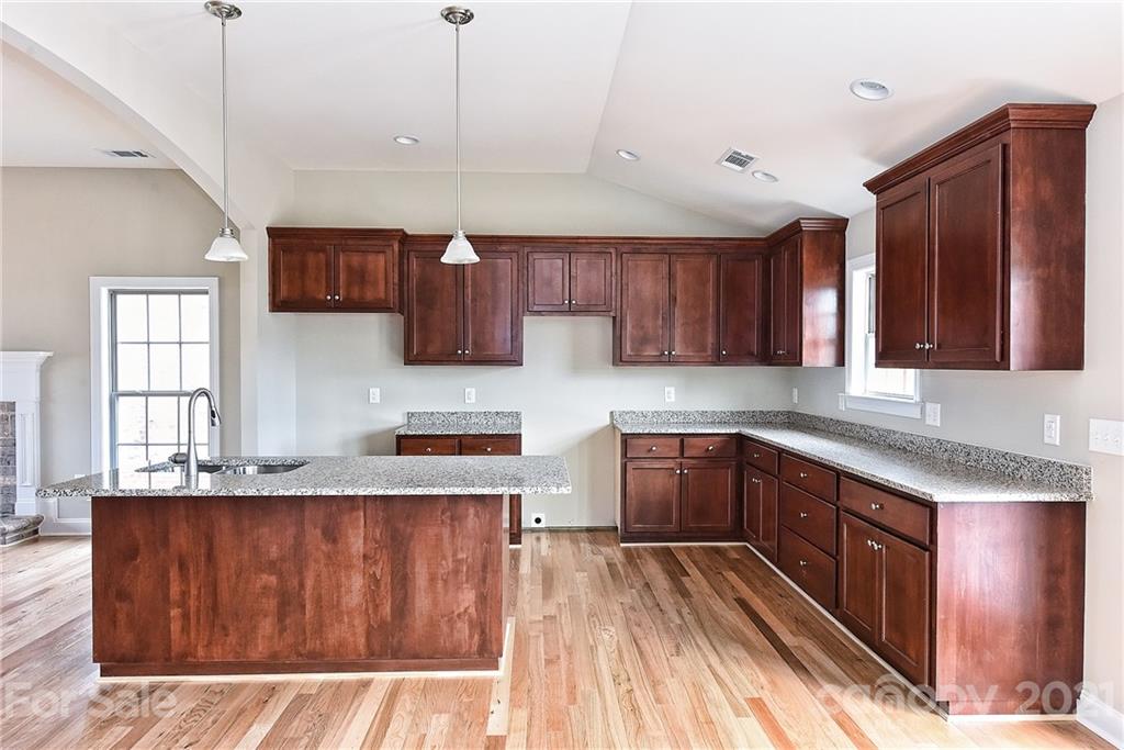 3324 Sincerity Road, Unit 6 Monroe, NC 28110 - Photo 13 of 29 a kitchen with stainless steel appliances granite countertop wooden cabinets a stove top oven a sink and dishwasher
