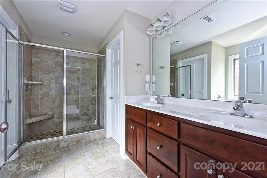 3324 Sincerity Road, Unit 6 Monroe, NC 28110 - Photo 19 of 29 a bathroom with a shower sink vanity granite and mirror