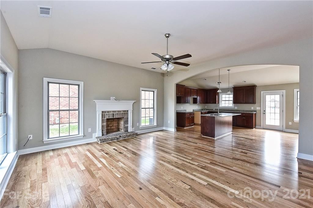 3324 Sincerity Road, Unit 6 Monroe, NC 28110 - Photo 6 of 29 a view of a kitchen with a stove cabinets and wooden floor
