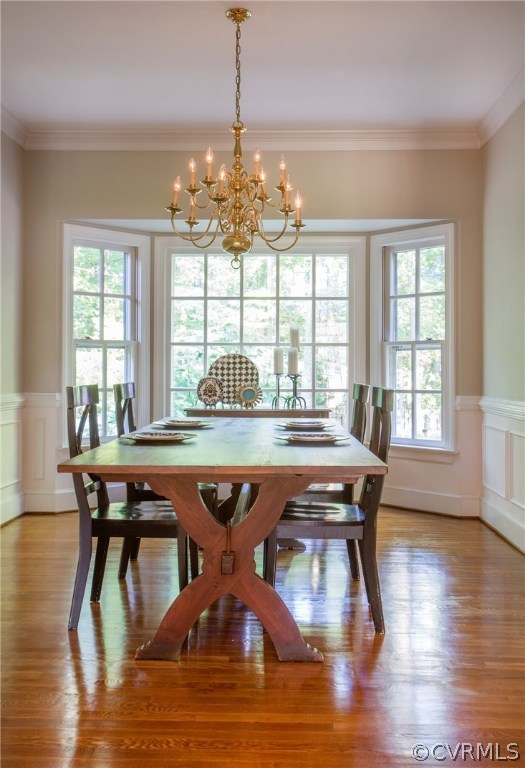4401 Uppingham Road Richmond, VA 23235 - Photo 5 of 23 a dining room with wooden floor a chandelier a glass table and chairs