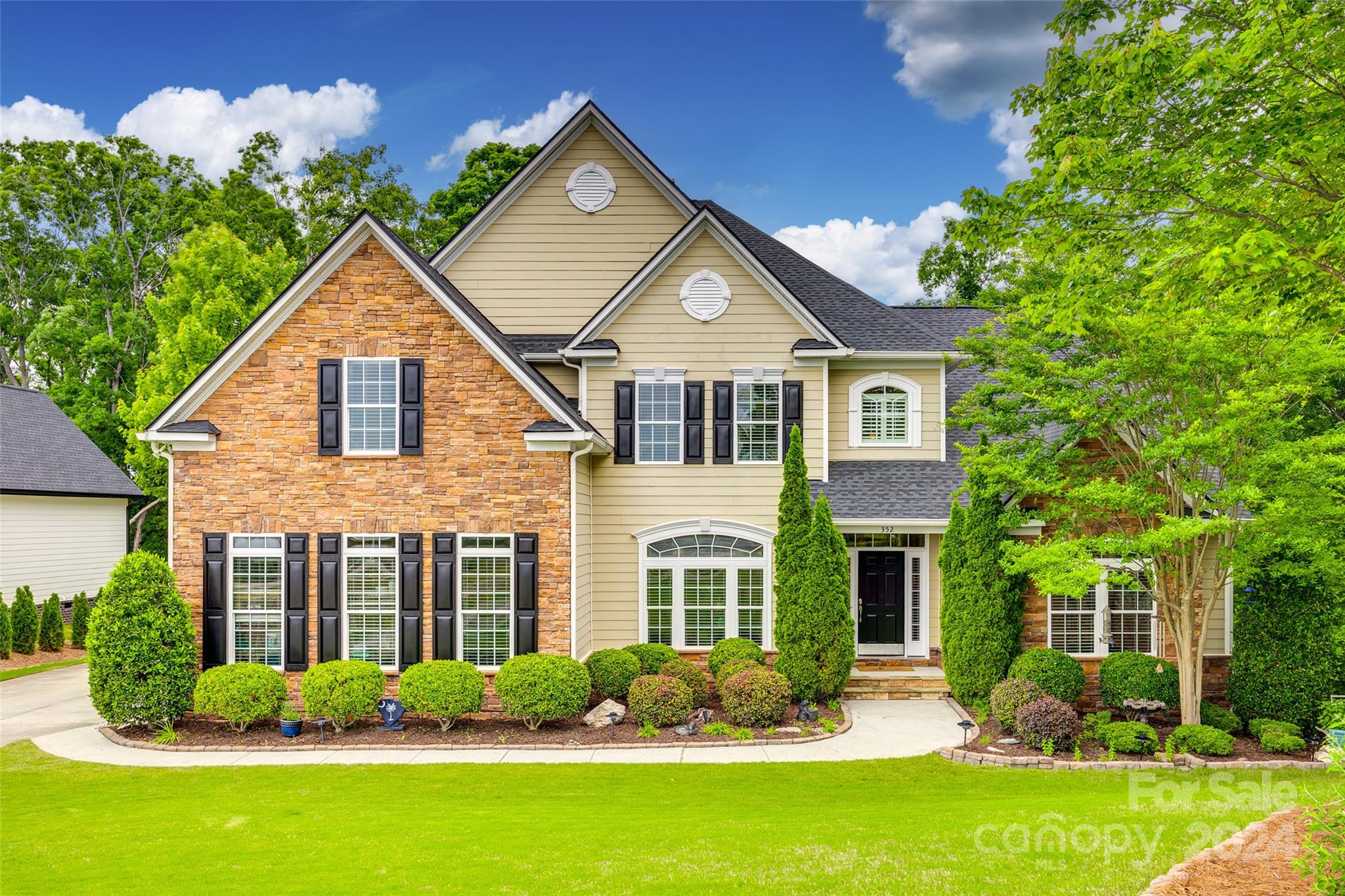 352 Calming Way Tega Cay, SC 29708 - Photo 1 of 48 a front view of a house with garden