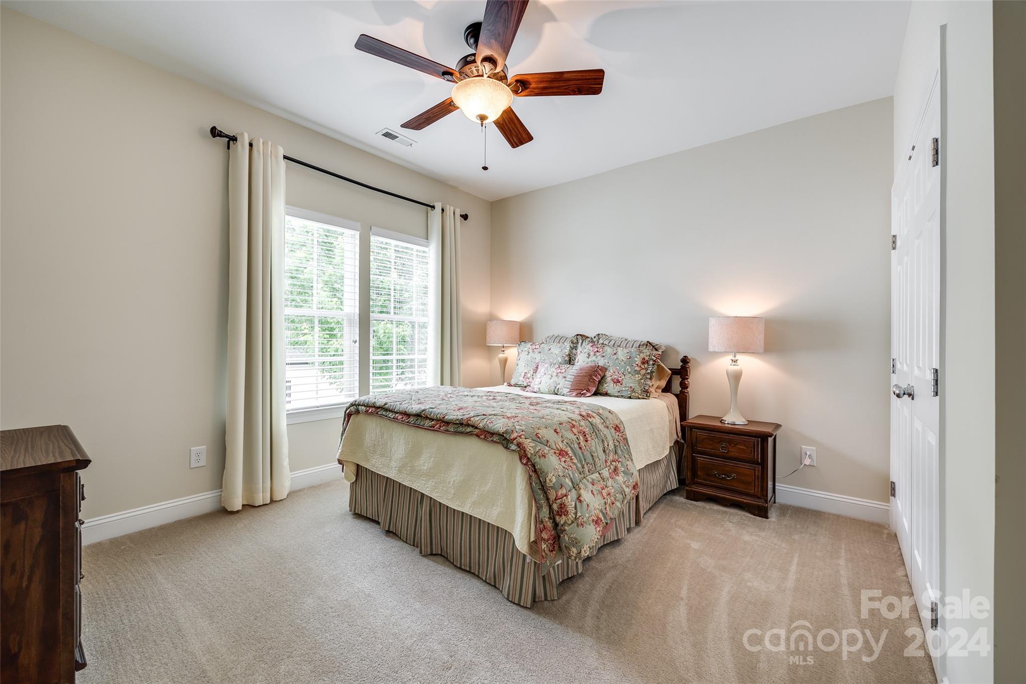 352 Calming Way Tega Cay, SC 29708 - Photo 31 of 48 a bedroom with a bed and a chandelier