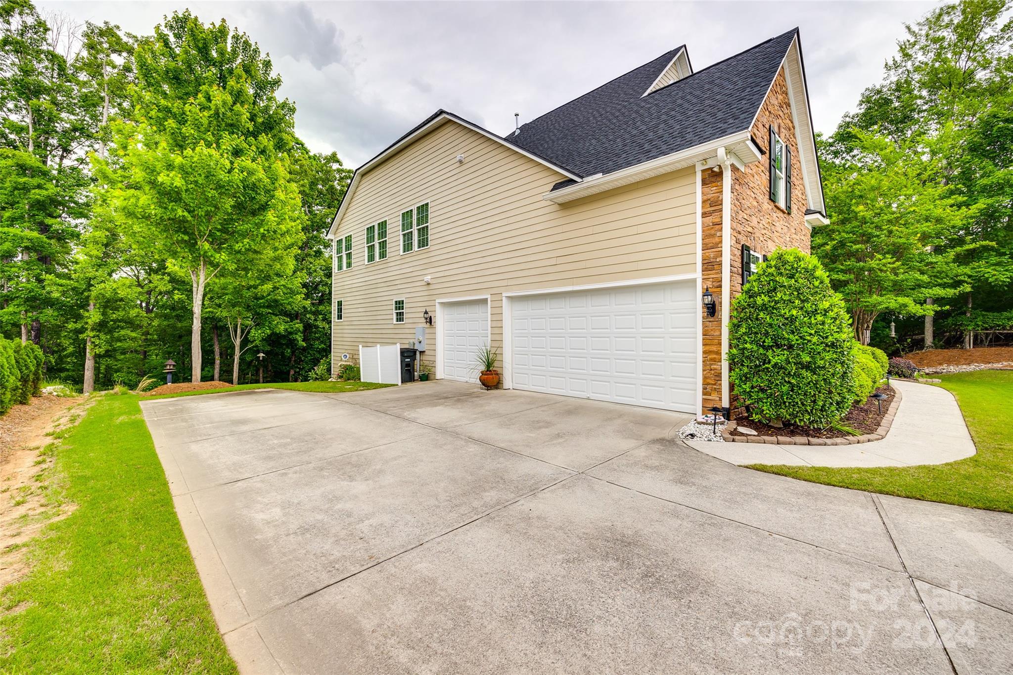 352 Calming Way Tega Cay, SC 29708 - Photo 43 of 48 a view of a house with a yard and potted plants