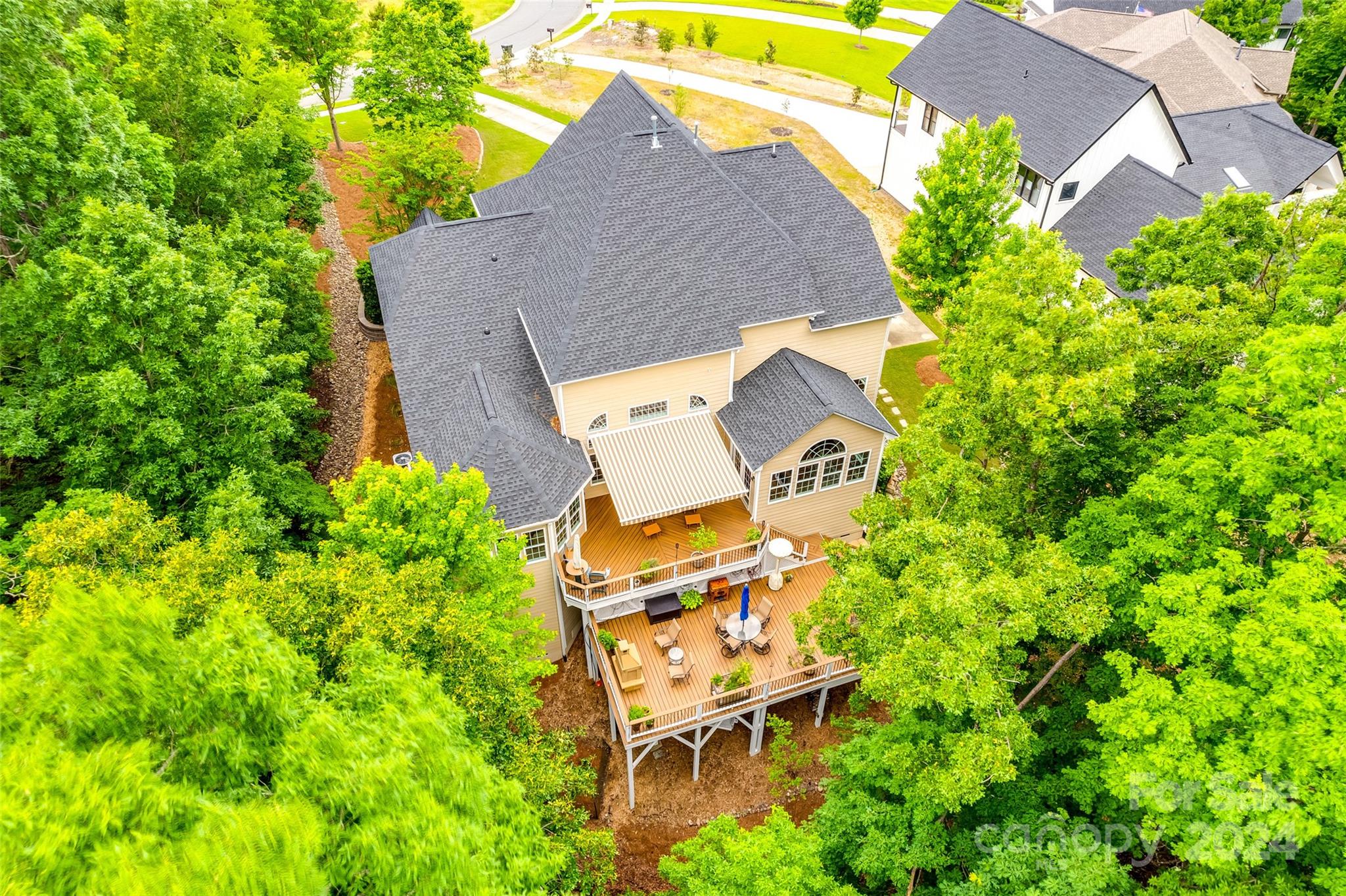 352 Calming Way Tega Cay, SC 29708 - Photo 46 of 48 an aerial view of a house with swimming pool and garden