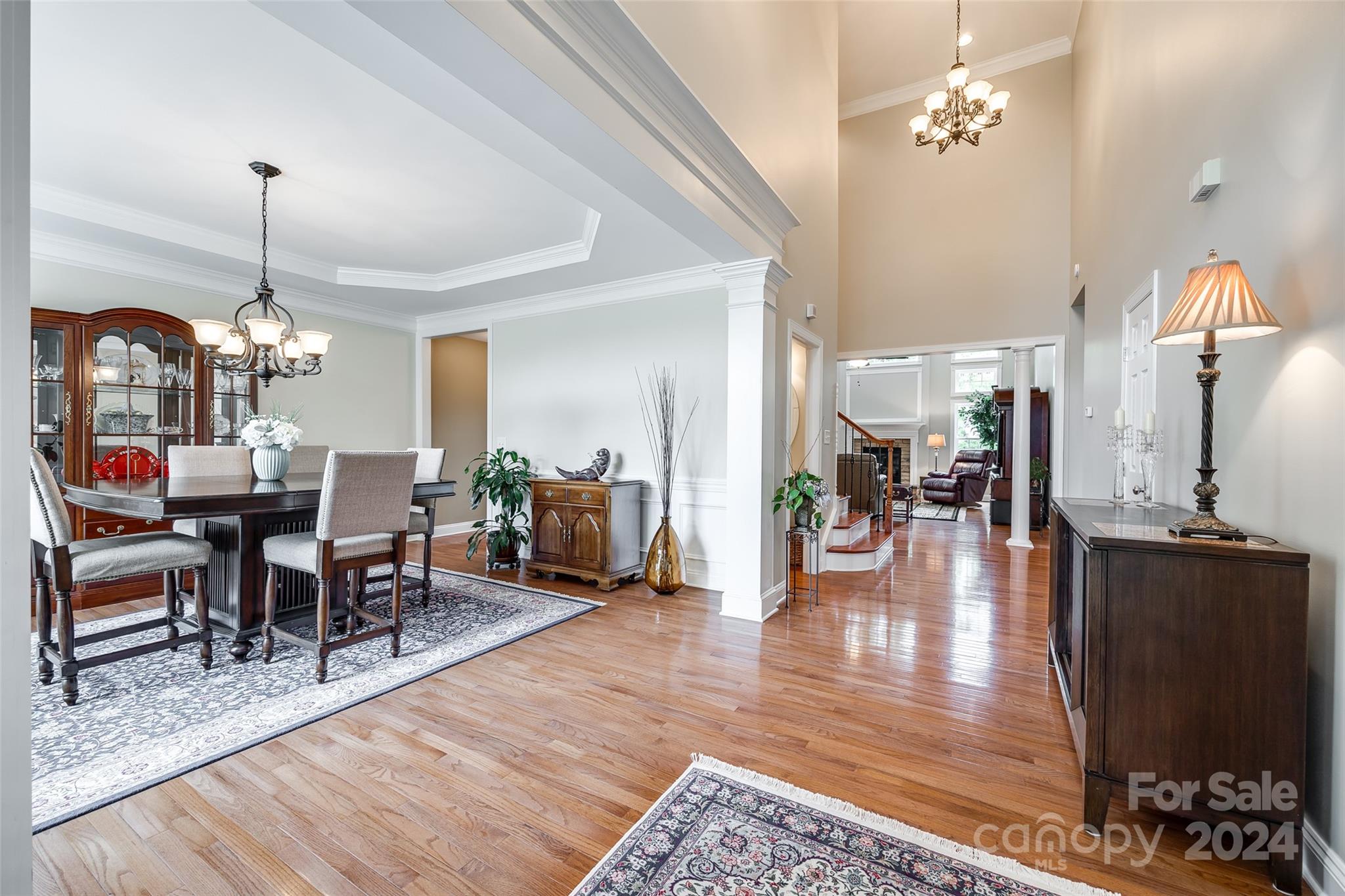 352 Calming Way Tega Cay, SC 29708 - Photo 5 of 48 a view of a dining room and livingroom with furniture wooden floor a chandelier