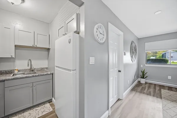 a white refrigerator freezer sitting inside of a kitchen