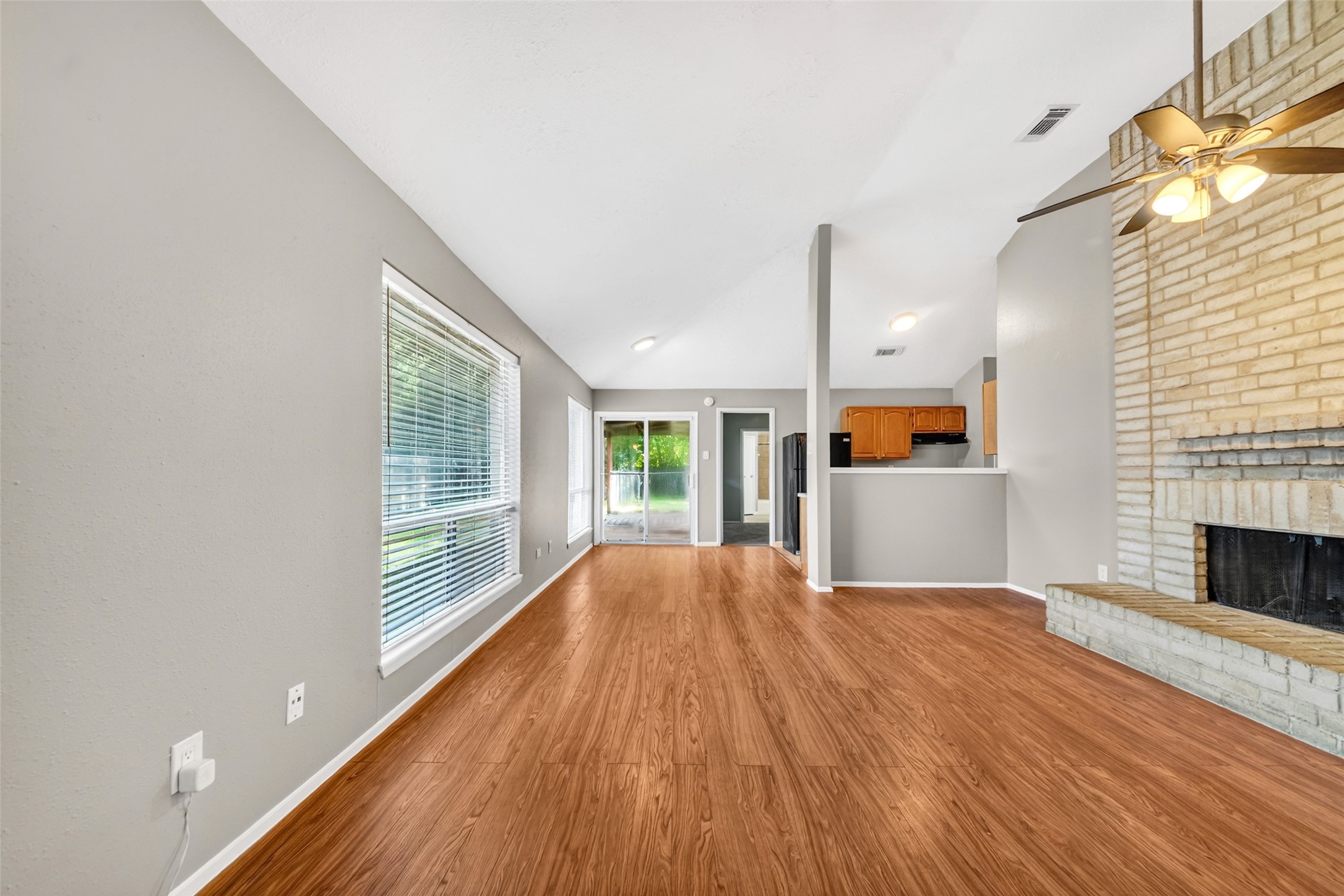3119 Oak Rock Spring, TX 77373 - Photo 2 of 25 a view of empty room with wooden floor and fireplace