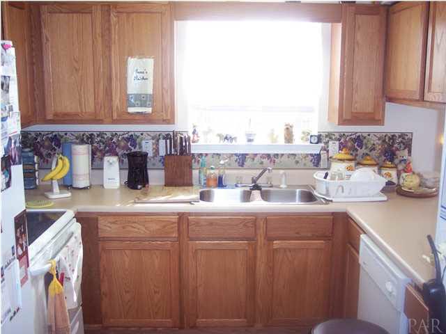 1098 Brownfield Road Pensacola, FL 32526 - Photo 6 of 16 View of kitchen from hallway. Smooth top stove.Refrigerator stays with new homeowner.