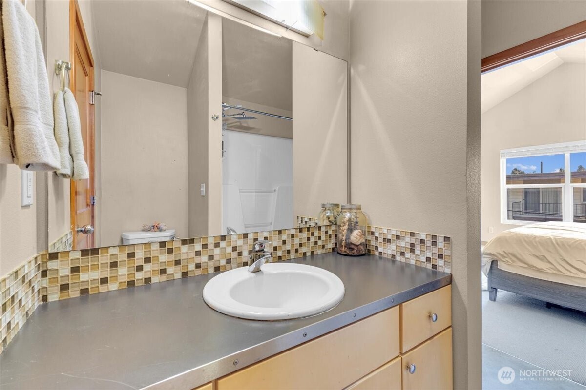1719 Southwest Henderson Street Seattle, WA 98106 - Photo 15 of 22 a bathroom with a sink and a mirror