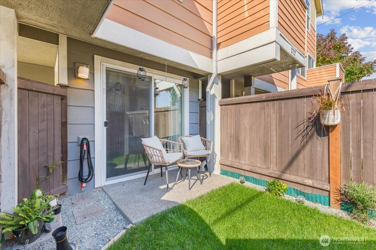 1719 Southwest Henderson Street Seattle, WA 98106 - Photo 3 of 22 a view of backyard of a house with yard and outdoor seating